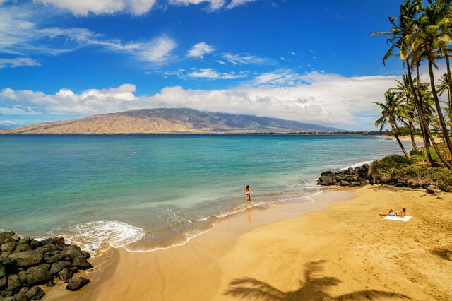 Aerial view of couple enjoying a gorgeous beach, Maui, Hawaii. 