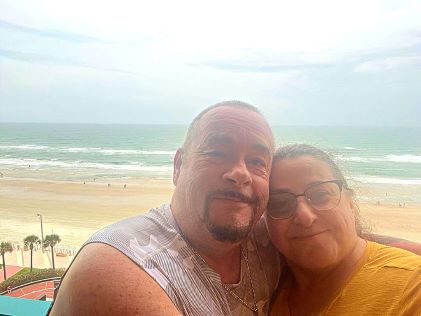A Hilton Grand Vacations Owner poses with her fiance at the beach in Daytona Beach, Florida