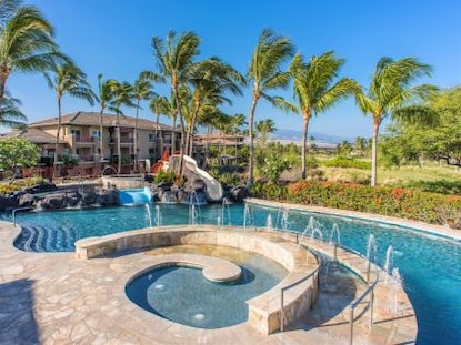 Pool and palm trees at Kohala Suites, a Hilton Grand Vacations Club