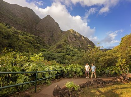 A couple walking through the lush Iao Valley in Maui, Hawaii