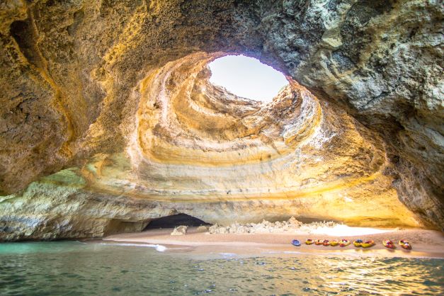 Image, kayaks lining the shoreline inside Benagil Caves, the Algarve, Portugal. 