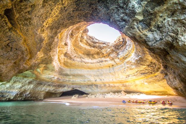 Image, kayaks lining the shoreline inside Benagil Caves, the Algarve, Portugal. 