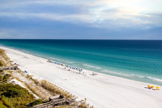 Beautiful aerial image, breach umbrellas peppered along sugar-white sands, Sandestin, Florida. 