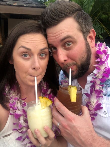 Hilton Grand Vacations Owners posing with tropical beverages before a luau, Hilton Waikoloa Village™, Big Island, Hawaii. 