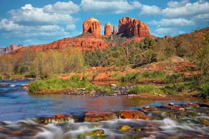 Beautiful image of Oak Creek with blue skies overhead and Cathedral Rock in the distance, Sedona, Arizona. 
