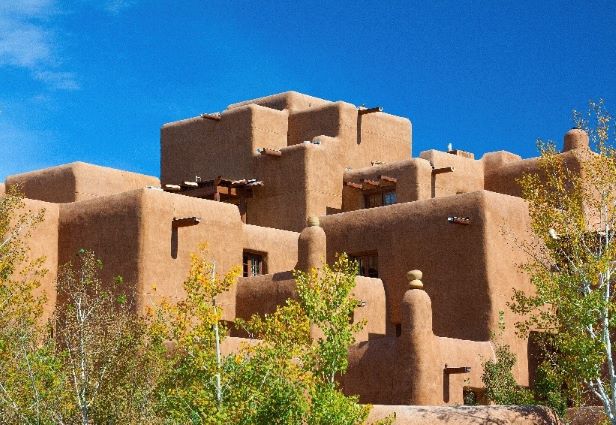 Iconic pueblo-style architecture set against the bright blue sky, Santa Fe, New Mexico.