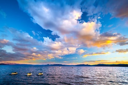Yellow Jet Skis® dotting Lake Tahoe, sunset painted skies overhead, California. 