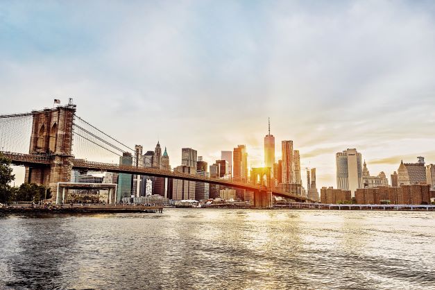New York City's skyline and Brooklyn Bridge at sunset