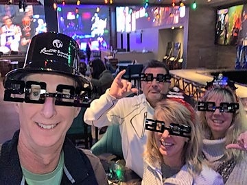 Hilton Grand Vacations Owners posing with friends in New Year's Eve glasses, Las Vegas, Nevada. 