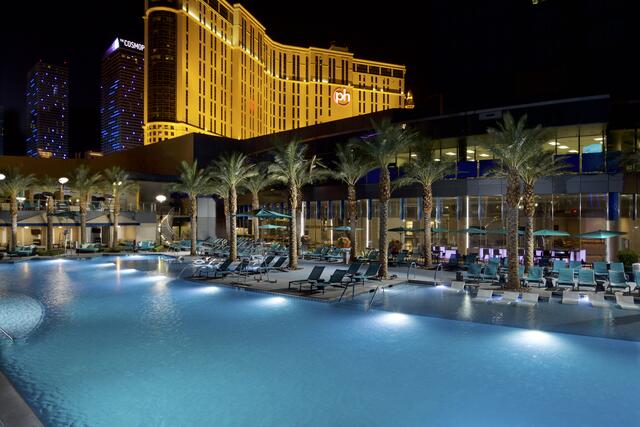 Beautiful aerial image of Elara, a Hilton Grand Vacations pool lit up at night, Las Vegas. 