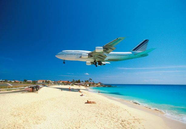 Stunning image, large commerical plane flying lowly over Maho Beach, St. Maarten, Caribbean. 