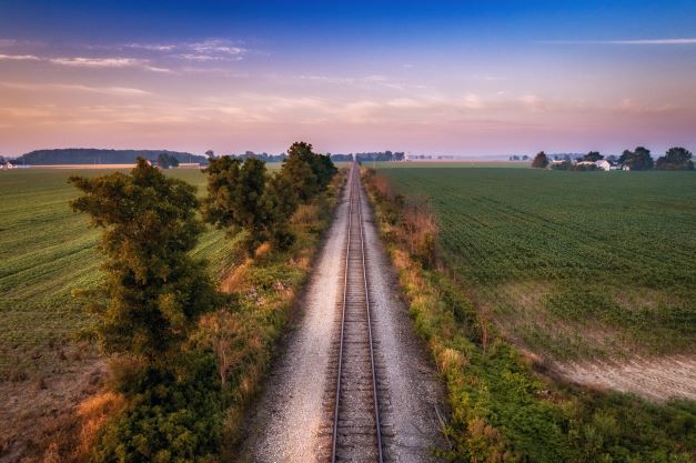 A railroad track between fields and trees in Ohio