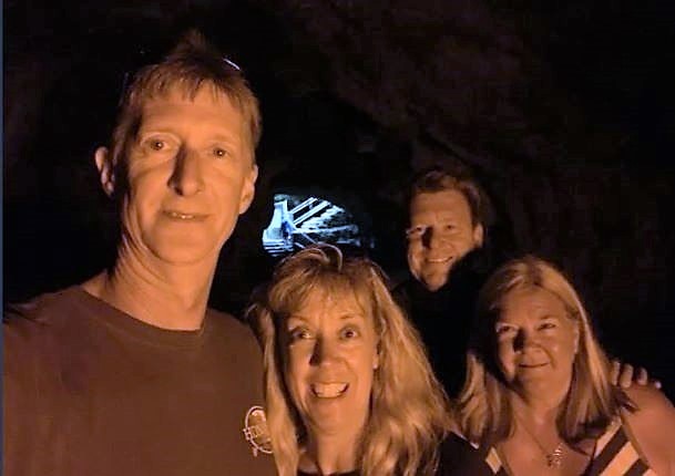 Hilton Grand Vacations Owners posing in lava tube on Big Island vacation, Hawaii. 