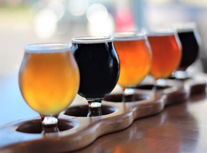 A sampler of round glasses with varying types of beer