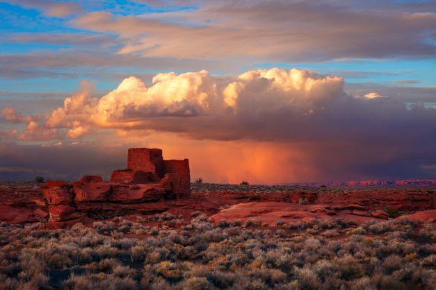 A rainstorm at sunset in the desert landscape of Lomaki Pueblo Ruins in Wupakti National Monument near Sedona, Arizona