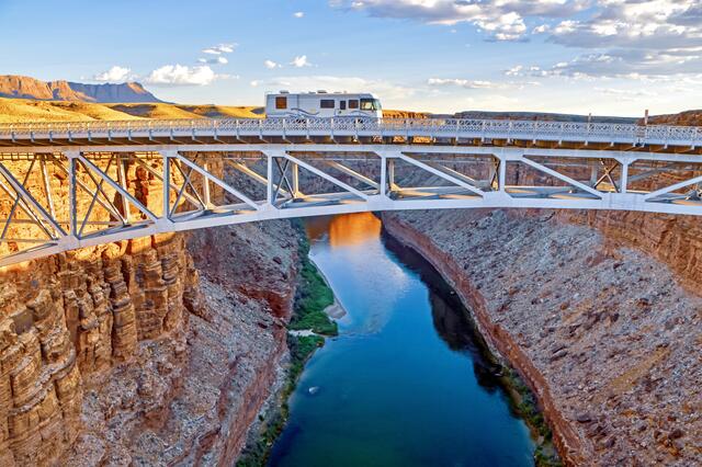 Gorgeous aerial image of RV crossing bridge, Nevada. 