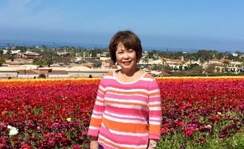 Hilton Grand Vacations Owner, posing with picturesque Carlsbad Flower Fields, Carlsbad, California. 