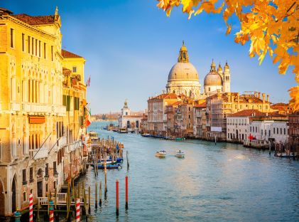 A sunny evening view of the Grand Canal and Basilica Santa Maria della Salute in Venice, Italy