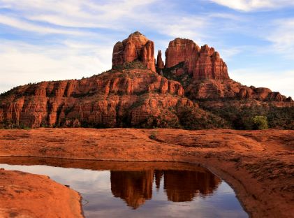 Cathedral Rock and its reflection in a pool of water in Sedona, Arizona