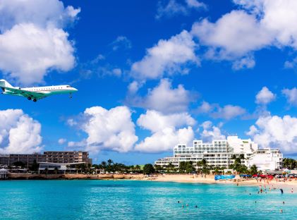 A plane landing at Princess Julianna International Airport near Maho Beach on St. Maarten