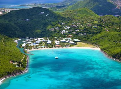An aerial view of the lush green hills and blue waters of St. Maarten