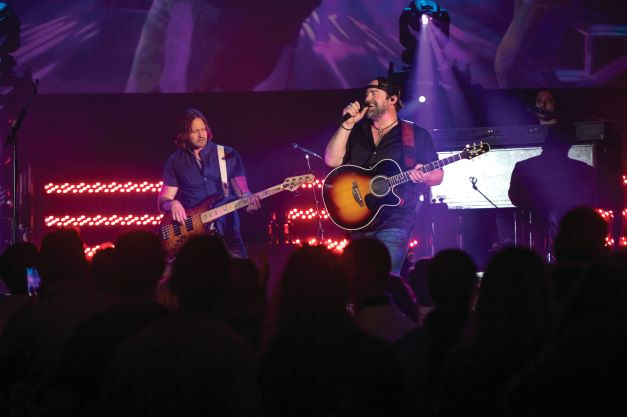 Hilton Grand Vacations Brand Ambassador Lee Brice on stage a HGV Live! show.