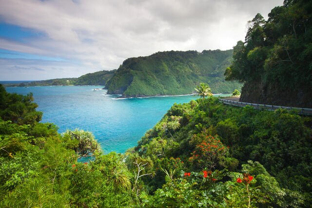 Stunning aerial vista, lush greenery, turquoise waters, blue skies, Maui, Hawaii. 