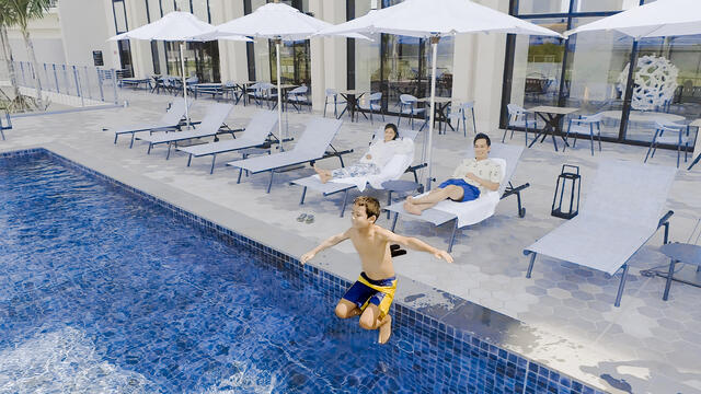 Kids jumping in pool, adults watching on, The Beach Resort Sesoko, a Hilton Club, Japan.