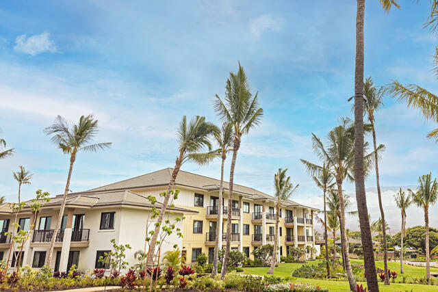 Exterior shot, Maui Bay Villas, a Hilton Grand Vacations Club, blue skies, beautiful flowers, palm trees swaying, Hawaii.