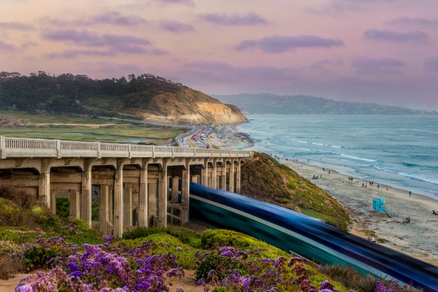 Stunning rail road track along Pacific coastline, purple painted skies, Southern California. 