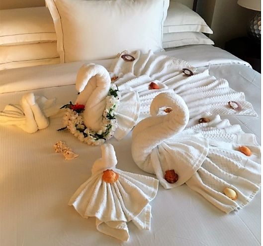 Thoughtfully made towel animal displays atop beautifully-made King size bed, Grand Waikikian, a Hilton Grand Vacations Club, Oahu, Hawaii.