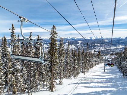 Ski chair lift above snowy forest in Breckenridge, Colorado