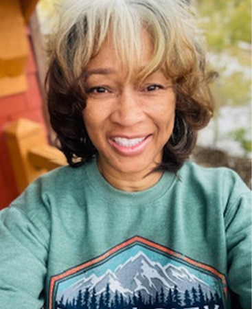 Sheryl B, a Hilton Grand Vacations Owner, poses for a selfie