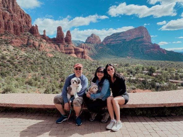 Hilton Grand Vacations Owner Raeanne pose with her family and two dogs at red rock formations near Sedona, Arizona, while on a road trip