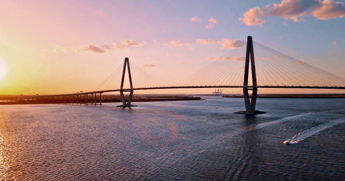Arthur Ravenel Jr. Bridge at sunset, boats in bay, Charleston, South Carolina. 