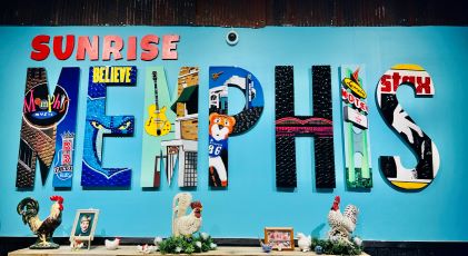Art piece of big block letters that read "Memphis," and in each letter is an aspect of Memphis, including Beale Street and the Memphis Grizzlies basketball team