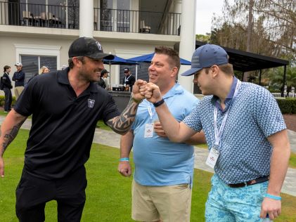 Singer Michael Ray fist bumps a Hilton Grand Vacations Owner at the 2023 Hilton Grand Vacations Tournament of Champions