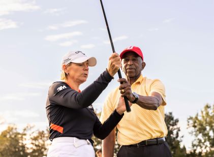 Annika Sorenstam coaches a Hilton Grand Vacations Owner on their grip at an HGV Ultimate Access event