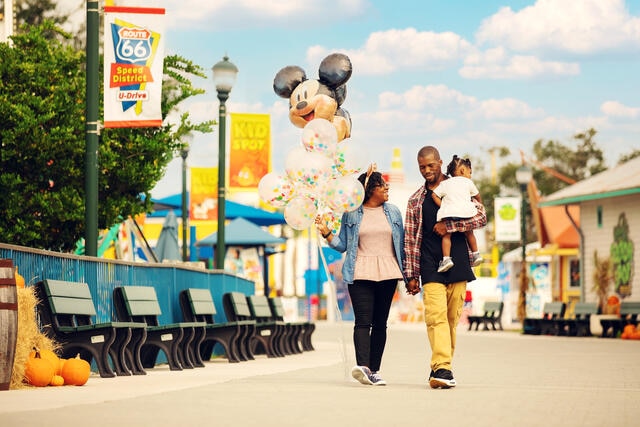 Family walking through Orlando theme park, Florida. 