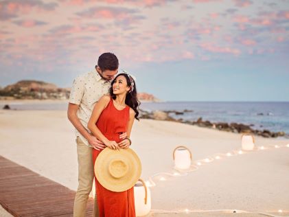 A couple posing on the beach by La Pacifica Los Cabos, a Hilton Club in Los Cabos, Mexico