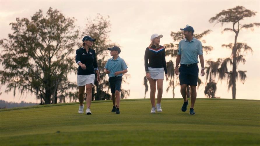Annika Sorenstam with her husband and two kids on a golf course at sunset