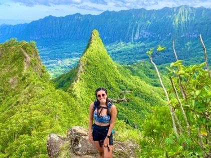 A Hilton Grand Vacations Owner on a hike of Olomana Trail in the lush greenery of Oahu, Hawaii