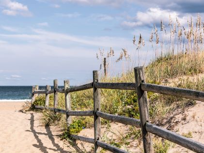 Wooden fence on a sandy trail to Sandbridge Beach in Virginia Beach, Virginia