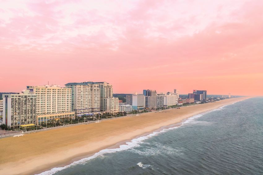 Aerial view of resorts along Virginia Beach, Virginia at sunset, including Oceanaire, a Hilton Vacation Club