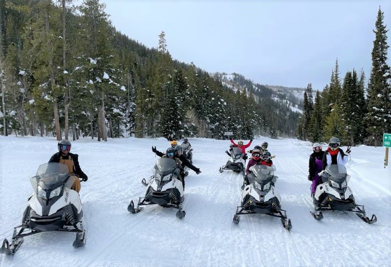 A Hilton Grand Vacations Owner and her travel party snowmobiling in Park City, Utah