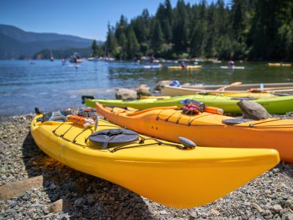 Colorful kayaks on the shore of Deep Cove near Vancouver, British Columbia, Canada, on a sunny day