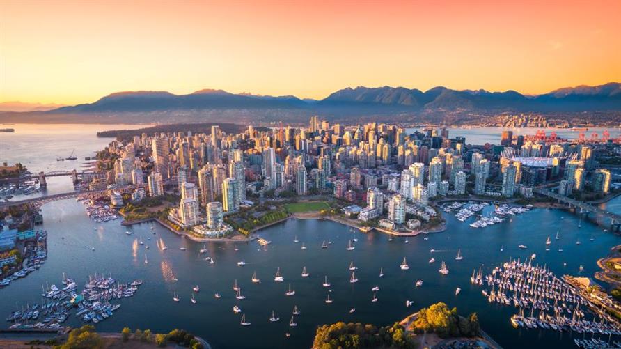 Aerial of Downtown Vancouver skyline and bay at sunset