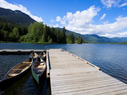 A floating dock and canoe at one of the lakes near Whistler, Canada