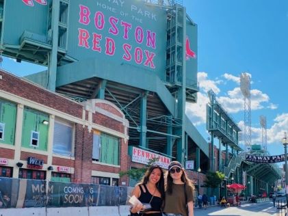 A Hilton Grand Vacations Owner and her friend at Fenway Park on a trip to Boston