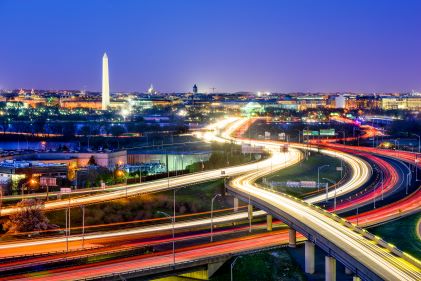 Washington D.C., highways glowing, nighttime view. 